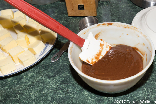 Gianduja ganache cooling next to plate of butter chunks