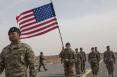 Military Men Holding American Flag