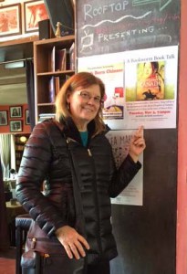 Dori Jones Yang poses by the poster announcing her November 2016 author talk in Beijing