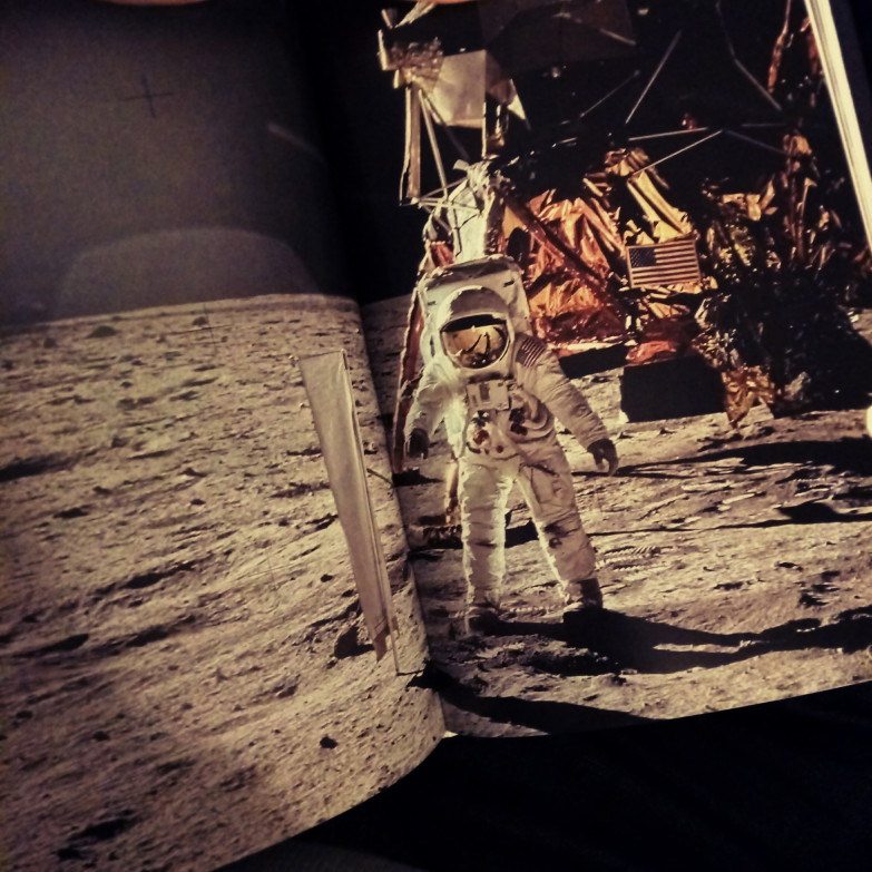 Buzz Aldrin sets up an experiment on the moon (from Moonfire by Norman Mailer)