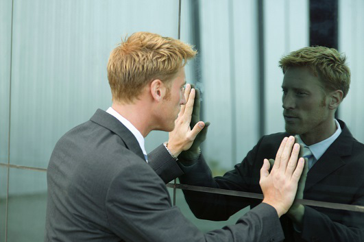 Man looking at himself in a mirror